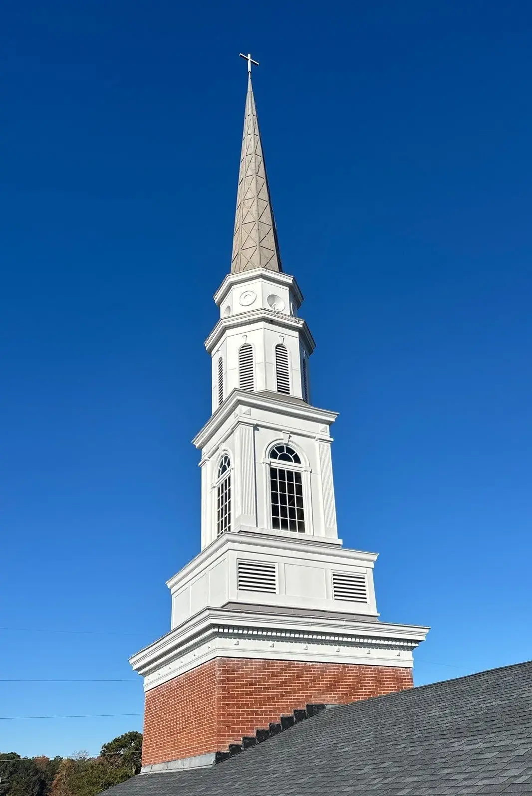 Bright, freshly painted white trim, fascia, and soffit contrasting against the brick facade of the Berean Seventh-Day Adventist Church in Atlanta.