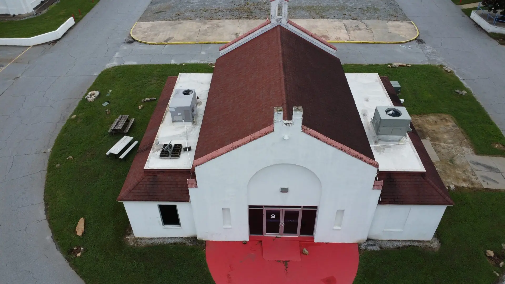 Firehouse building at Cinespace Studios Atlanta showing aged architectural shingle roof and rotten fascia/soffit trim.