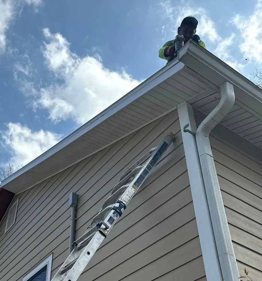 Newly installed 6-inch K-style gutters with protective screens on a home's exterior.