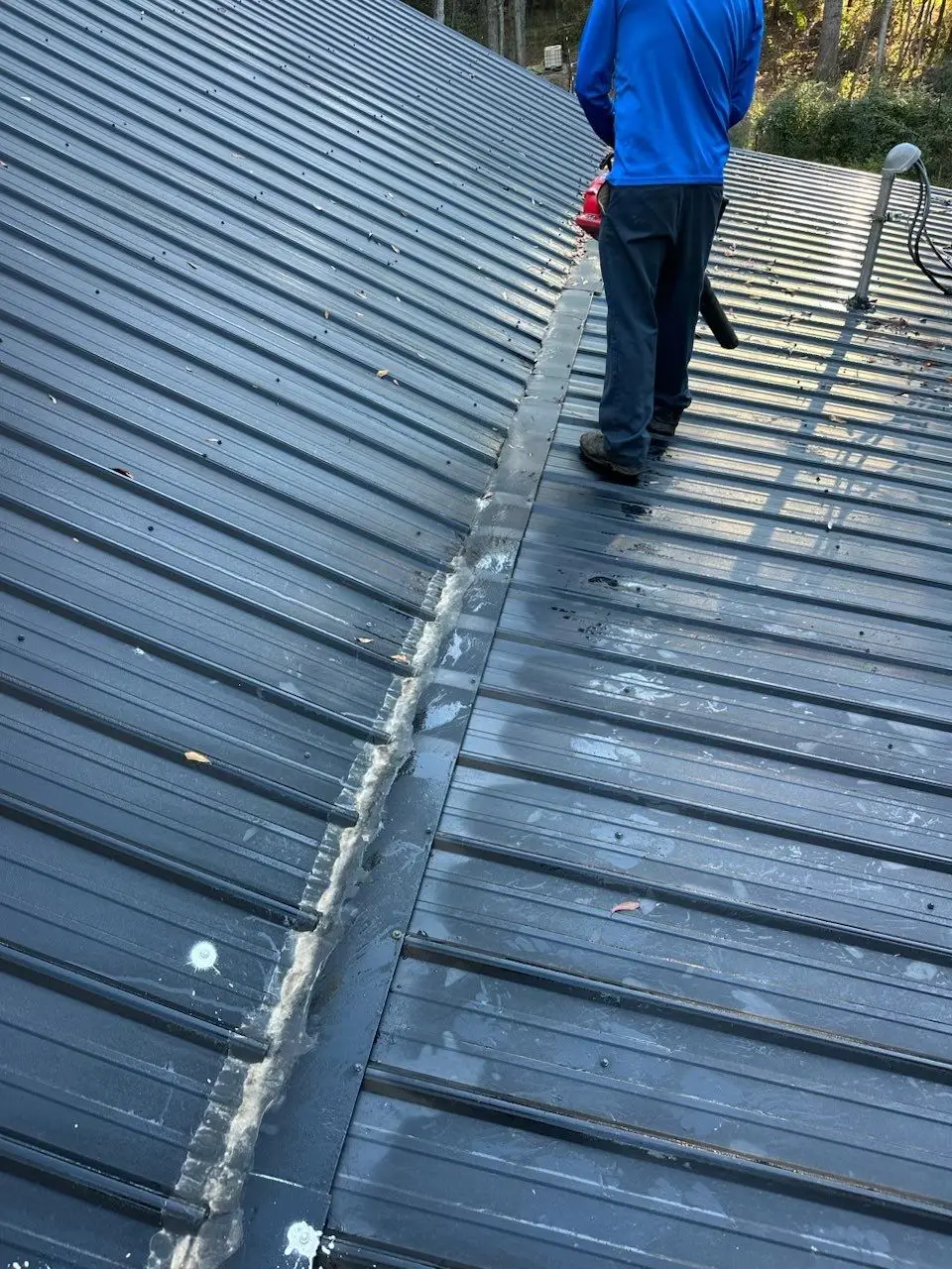 Rusted, leaking, and improperly fastened metal roof on the porch of a home in Villa Rica, GA.