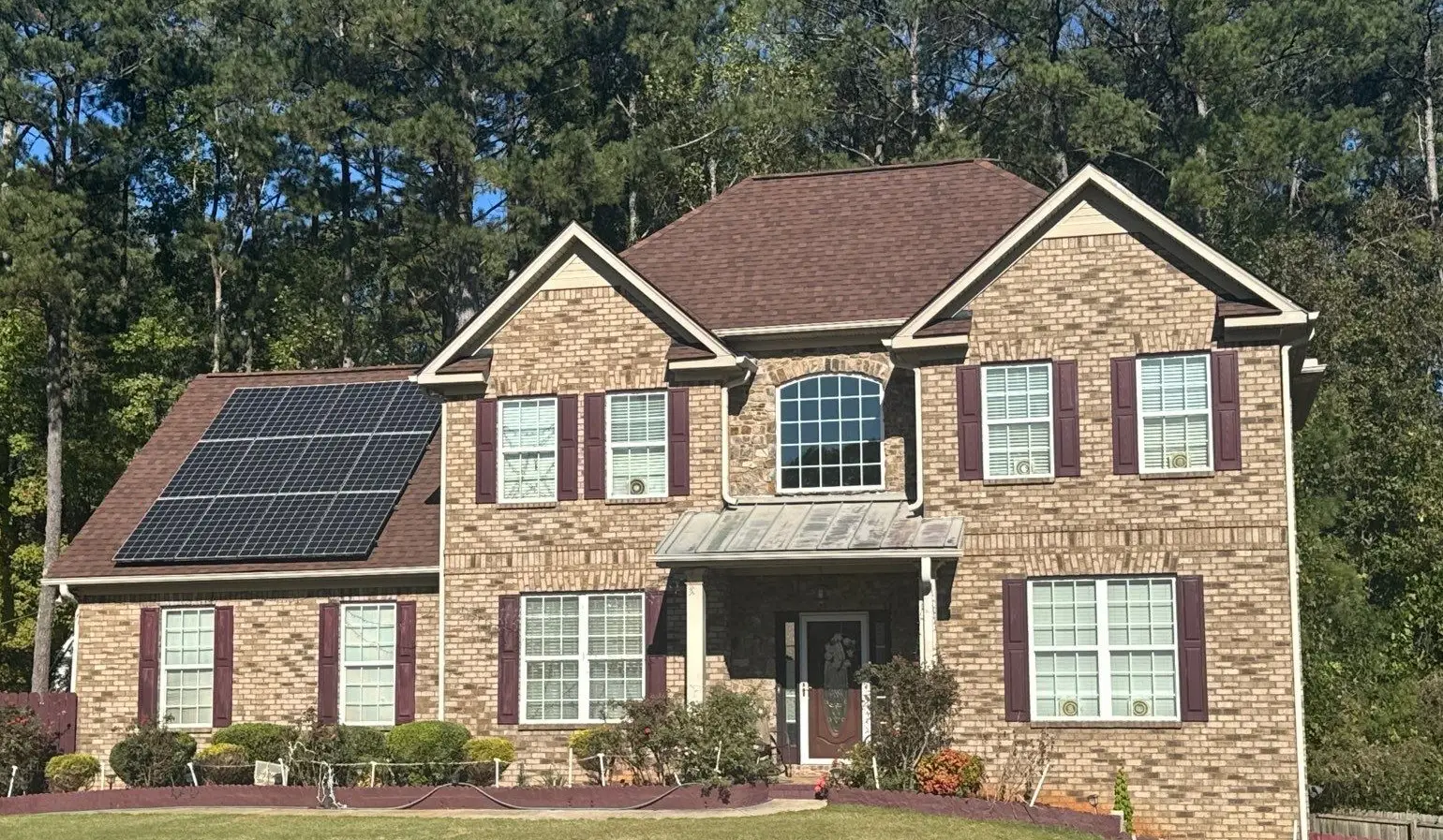 Newly installed architectural shingle roof system with solar panels reinstalled on a home in Villa Rica, GA.