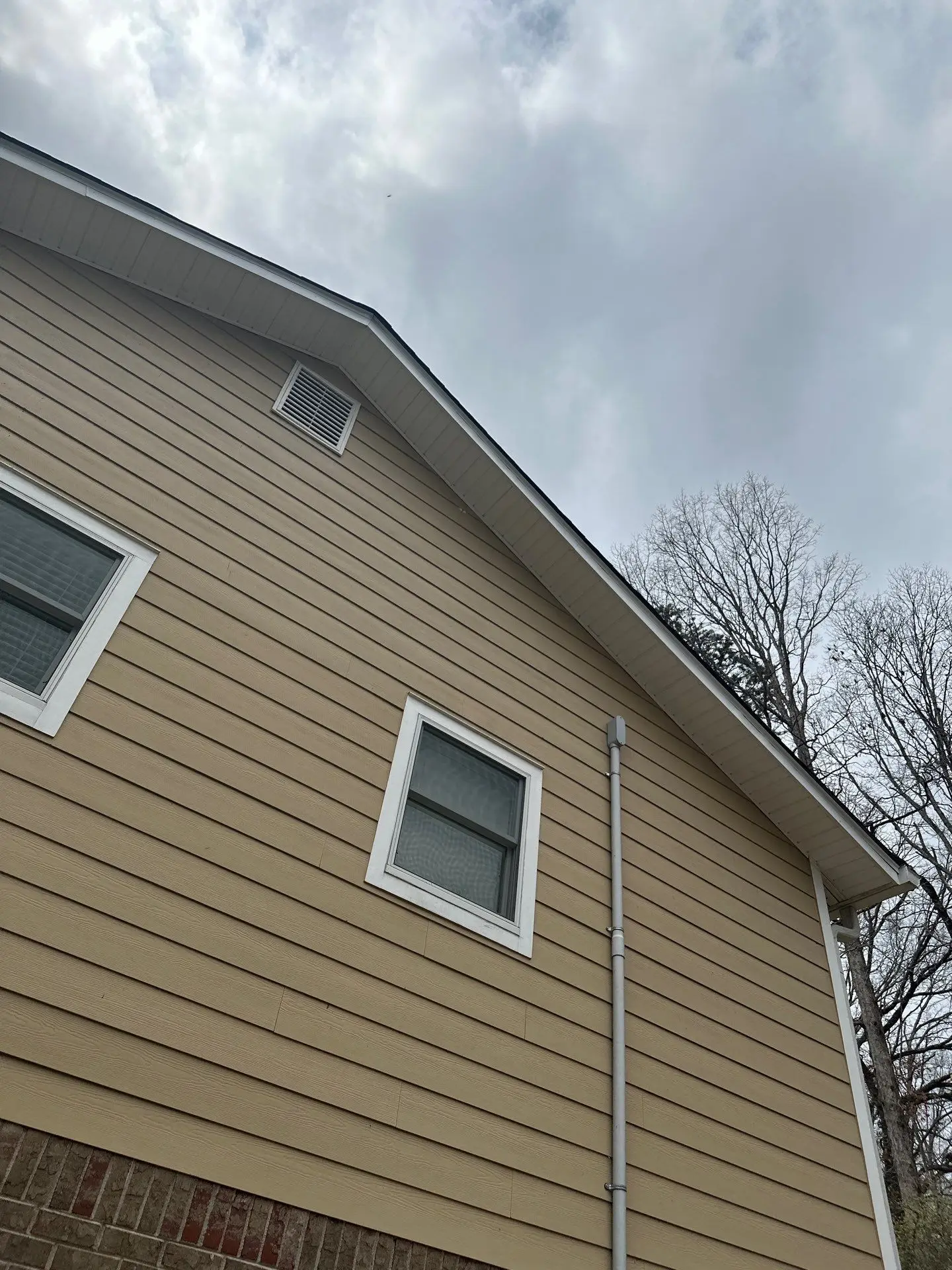 Fully repaired right roof slope in Marietta, GA with new siding, shingles, and synthetic underlayment.