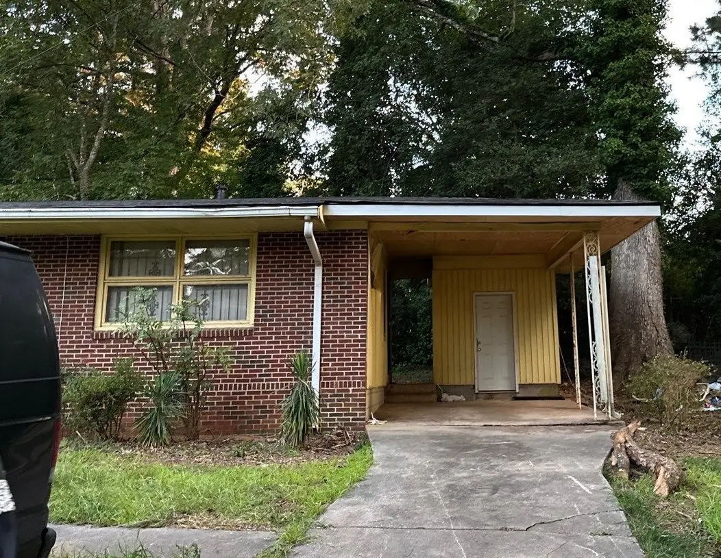 Fully renovated single-story home in East Point with a new GAF asphalt shingle roof, new siding, and restored structural elements.